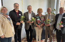 Gruppenbild von 5 Personen, die jeweils eine Blume in den Händen halten